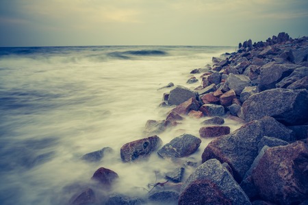 Beautiful seascape of Baltic sea rocky shore. Photo with vintage mood.