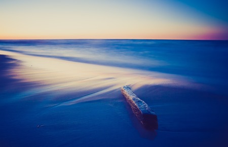 Beautiful landscape of seashore at sunset. Photo with vintage mood effect