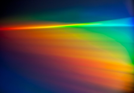Closeup of rainbow colored reflection on CD, useful as backgroundの写真素材