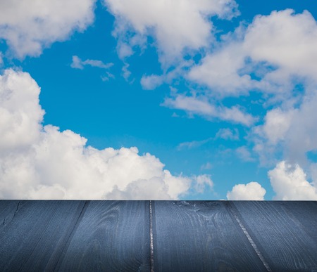 Wooden floor with cloud and blue sky. Abstract background with wooden planksの写真素材