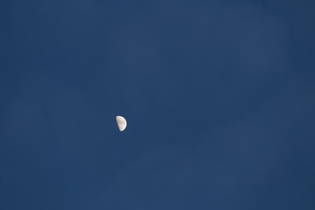 Half moon on dark sky background. Close up of moon.の写真素材