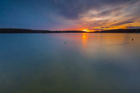 Beautiful long exposure landscape of lake in Mazury lake district (Krzywe lake near Olsztyn).