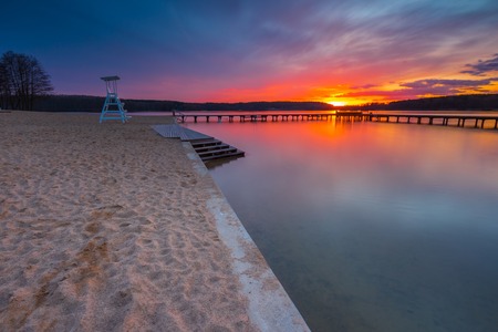 Beautiful lake landscape with vibrant sunset. Long exposure landscape.の写真素材