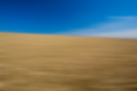 Blurry, defocused field landscape useful as background. Out of focus landscape.の写真素材