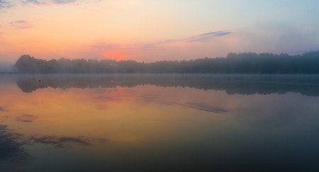 Beautiful, mystic sunrise over lake. Summertime in Mazury lake district.の写真素材