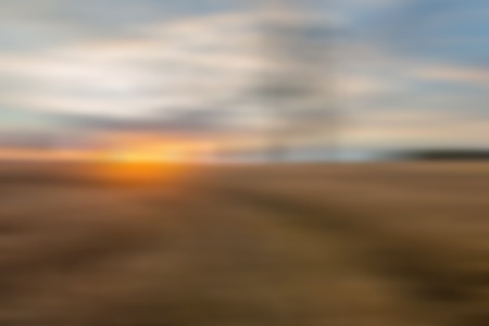 Blurry, defocused field landscape useful as background. Out of focus landscape.の写真素材