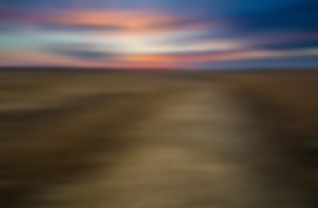 Blurry, defocused field landscape useful as background. Out of focus landscape.の写真素材