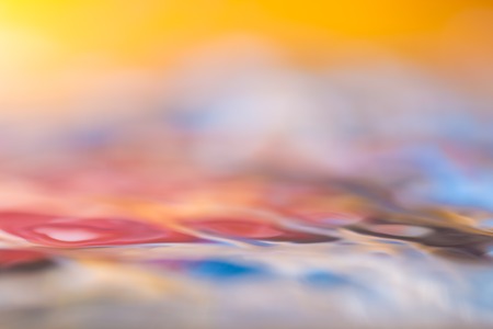 Colorful moving liquid abstract. Close up of moving water surface.の写真素材