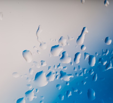 Water droplets on glass surface. Close up of raindrops on glass.の写真素材