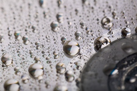 Water droplets on CD, abstraction. Water on compact disc surface.の写真素材