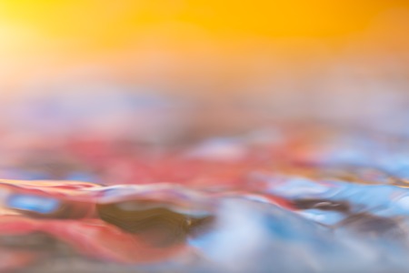 Colorful moving liquid abstract. Close up of moving water surface.の写真素材