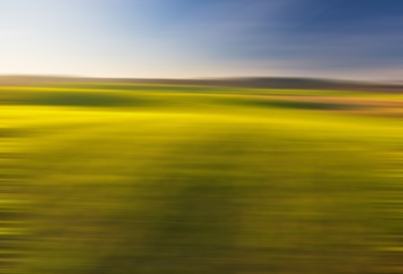 Blurry, defocused field landscape useful as background. Out of focus landscape.の写真素材