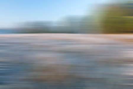 Blurry, defocused field landscape useful as background. Out of focus landscape.の写真素材