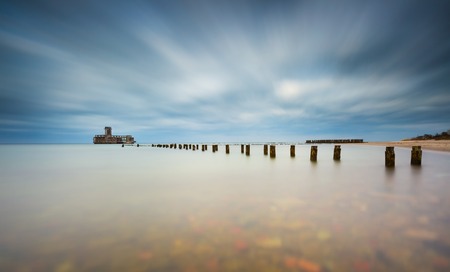 Beautiful view on Baltic rocky coast with old military buildings from world war II and wooden breakwaters.の写真素材