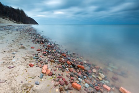 Beautifu rocky sea shore at sunrise or sunset. Long exposure landscape. Baltic sea near Gdynia in Poland.の写真素材