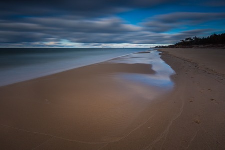 Baltic shore photographed on long exposure. Dark dramatic seascape of polish shore of Baltic sea.の写真素材