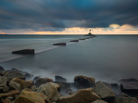 Mouth of the river Vistula in Gdansk. Long exposure seascape. Beautiful rocky breakwater on sea shore and protection walls on mouth of river.の写真素材