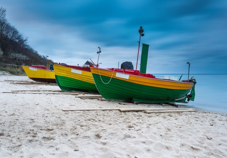 Landscape with Baltic Sea. Fishing boat on the beach. Tranquil evening landscape. Long exposure photoの写真素材