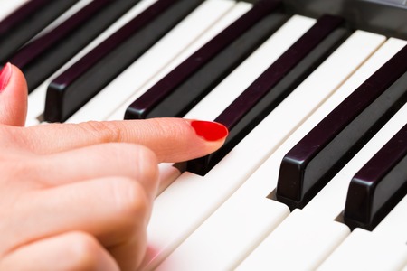 Close up of Keybord of synthetizer. Music abstract background with hands playing on keyboard.の写真素材