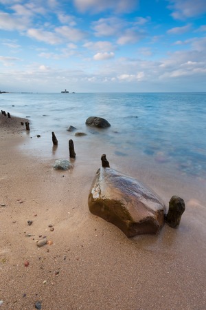 Beautiful long exposure landscape of rocky sea shore. Tranquil scene of Baltic sea near Gdynia in Poland.の写真素材