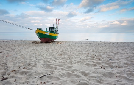 Landscape with Baltic Sea. Fishing boat on the beach. Tranquil evening landscape. Long exposure photoの写真素材