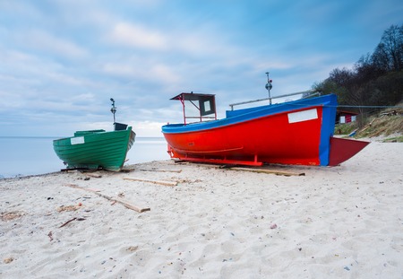 Landscape with Baltic Sea. Fishing boat on the beach. Tranquil evening landscape. Long exposure photoの写真素材