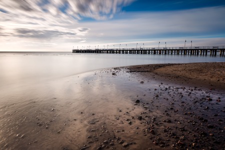 Beautiful pier in Gdynia, poland. Seascape with wooden molo in Orlowo. Landscape photographed before sunriseの写真素材