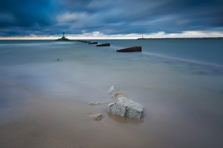 Mouth of the river Vistula in Gdansk. Long exposure seascape. Beautiful rocky breakwater on sea shore and protection walls on mouth of river.の写真素材