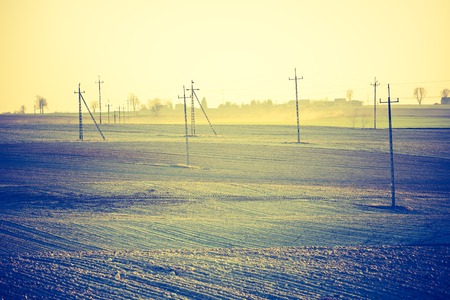 Vintage photo of plowed field in calm countryside. Agricultural landscape with old fashioned colorsの写真素材