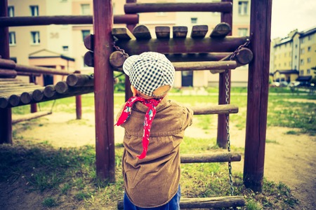 Vintage photo of Little child playing outdoor. photo with old colors effectの写真素材
