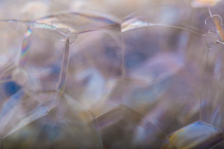 Close up of froth, abstract background. Air bubbles in soap foam.