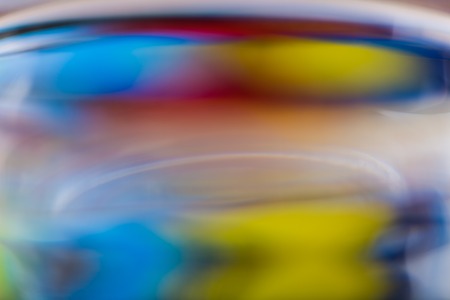 Abstract background of color reflections in thick glass vase. Macro abstract backgroundの写真素材