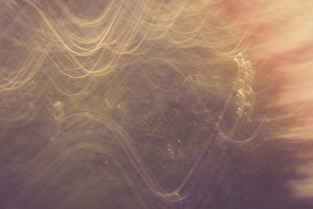 Vintage photo of blurry abstract background of green summer forest photographed on long exposure...