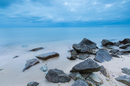 Beautiful long exposure landscape of rocky sea shore. Tranquil scene of Baltic sea.の写真素材