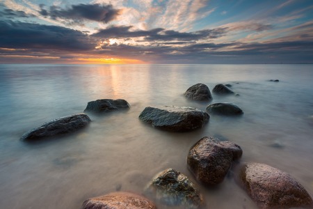 Beautiful long exposure landscape of rocky sea shore. Tranquil scene of Baltic sea.の写真素材
