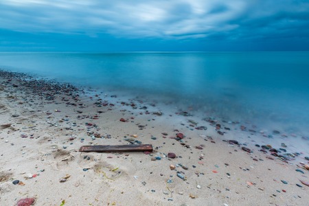 Beautiful long exposure landscape of rocky sea shore. Tranquil scene of Baltic sea.の写真素材