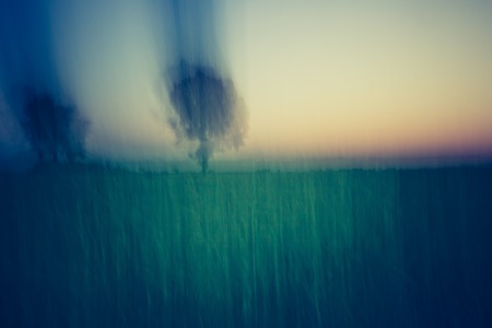 Abstract, blurry background of field after sunset. Photo with vintage moodの写真素材