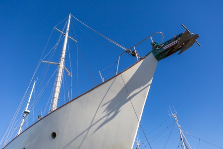 Part of big white ship moored in port. Port in Jastarnia, Poland.