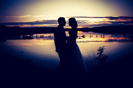 Vintage photo of silhouettes of wedding couple photographed in outdoor. の写真素材