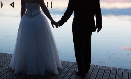 Vintage photo of silhouettes of wedding couple photographed in outdoor. の写真素材