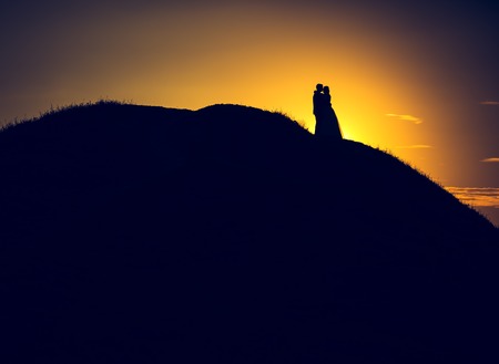 Vintage photo of silhouettes of wedding couple photographed in outdoor.  の写真素材