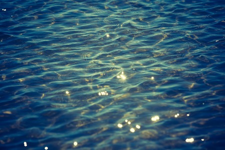 Vintage photo of blurry abstract background of defocused sea. の写真素材