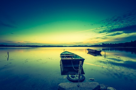 Vintage photo of beautiful lake sunset. Polish lake in Mazury lake district. Polish lake landscapeの写真素材