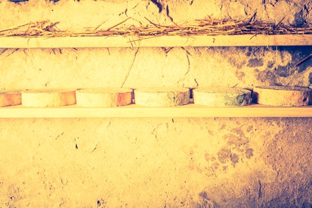 Vintage photo of cheese maturing in basement. French goat cheese. Studio shoot with mystic light effect.の写真素材