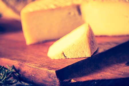 Vintage photo of still life with french goat cheese. Studio shoot with mystic light effect.