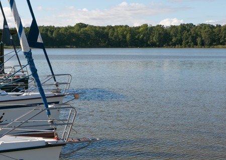Front part of yacht swimming on lake. Beutiful Mazury lake photographed from yacht.