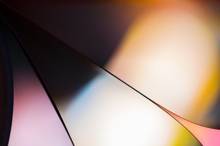 Colorful paper abstraction made with curved paper sheets and colorful lights.