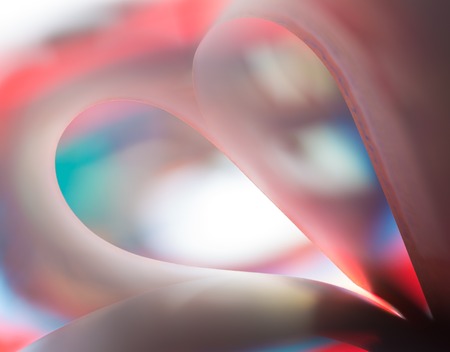 Colorful paper abstraction made with curved paper sheets and colorful lights.の写真素材