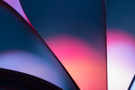 Colorful paper abstraction made with curved paper sheets and colorful lights.の写真素材