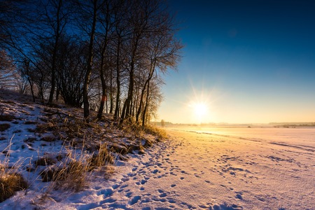 Beautiful cold morning on snowy winter countryside. Polish countryside at snowy winter.の写真素材